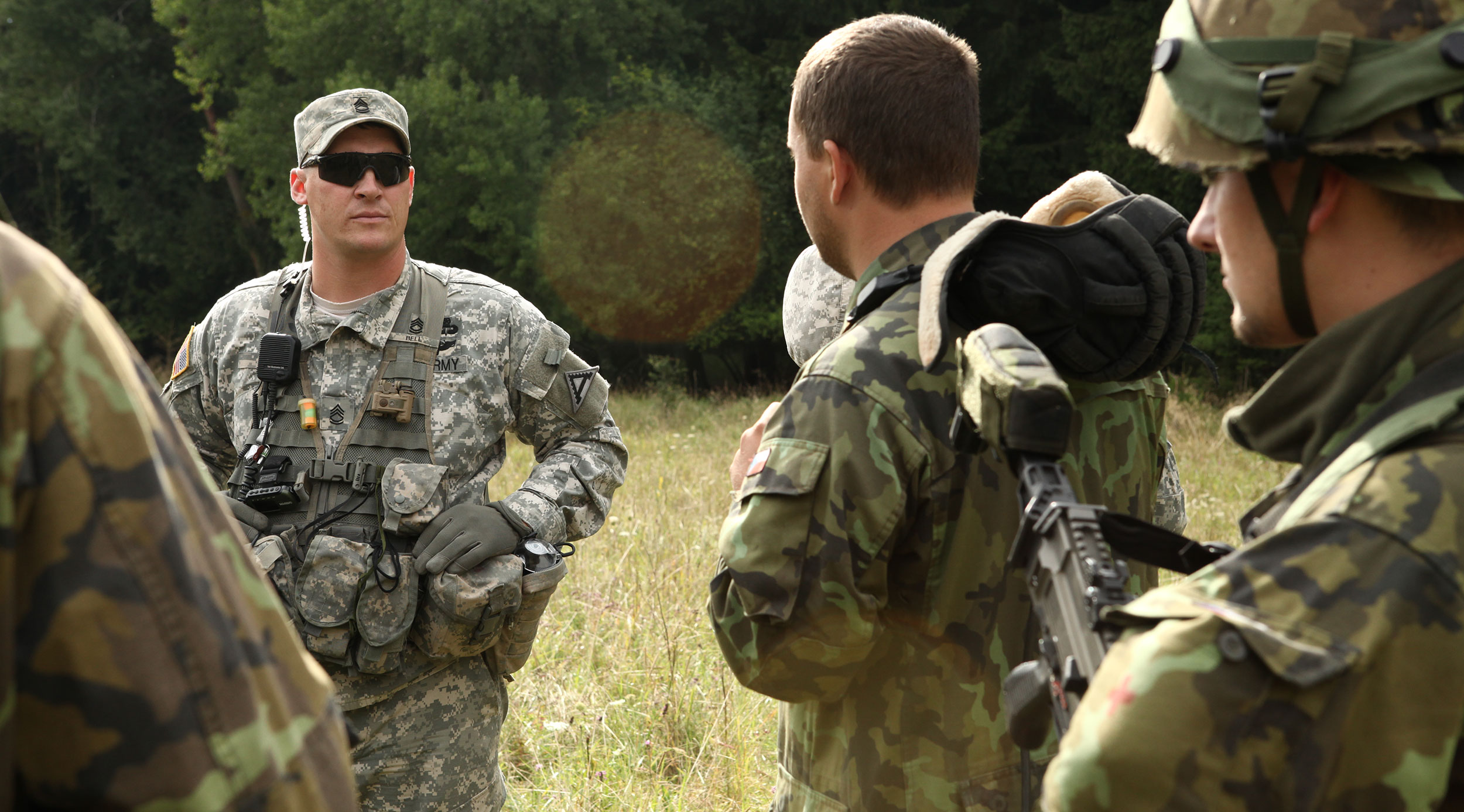 Then-Sgt. 1st Class Tyler Bell facilitates a hot wash with a Czech Republic Artillery Battery after conducting a Situational Training Exercise lane at the Joint Multinational Readiness Center. (Photo courtesy of 1st Sgt. Tyler Bell)